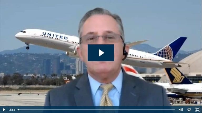 Man speaking with planes taking off in the background, business travel concept.