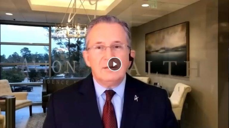 Business professional in an office setting with headset, discussing health topics.