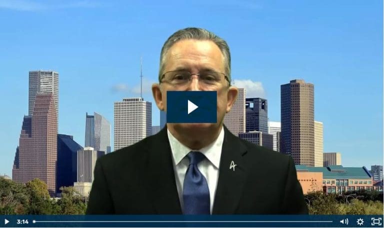 Man in suit with play button overlay, city skyline background.