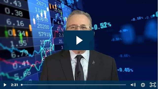 A man in front of digital stock market charts and data.