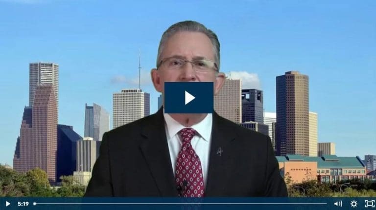 Man in suit with city skyline background and play button overlay.
