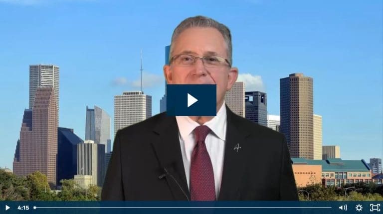 Man in a suit with a city skyline background.