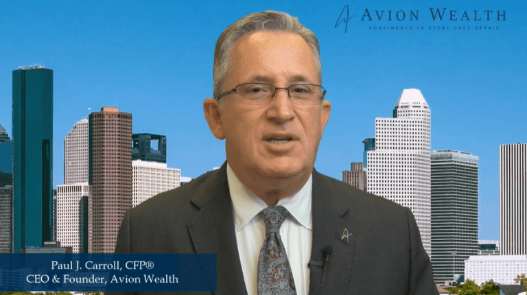 Executive in suit speaking against city skyline background.