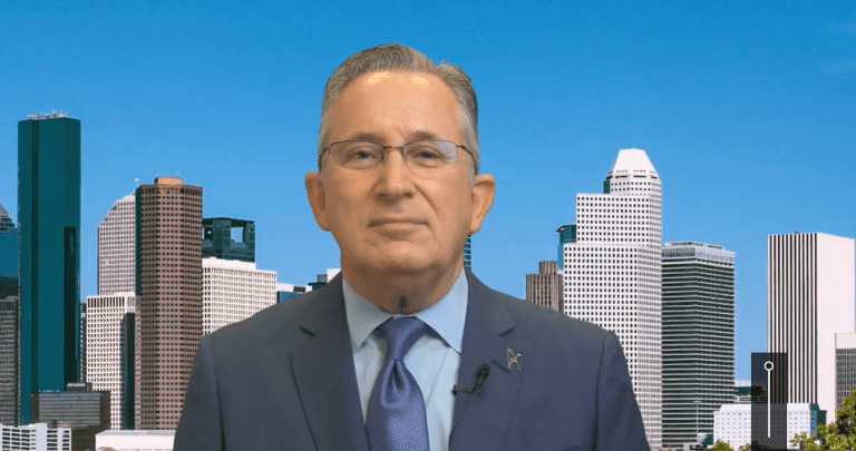 Man in suit with city skyline background.