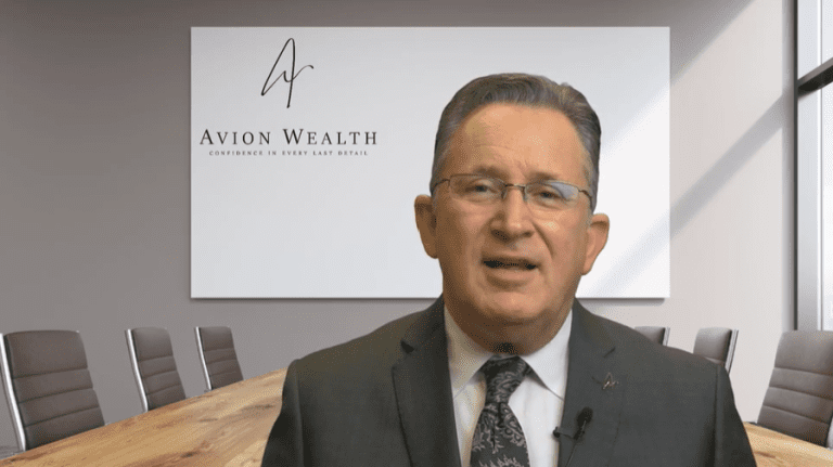 Man in suit speaks in Avion Wealth office conference room.