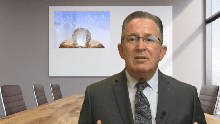 Businessman presenting in a boardroom with projection of a crystal ball graph.