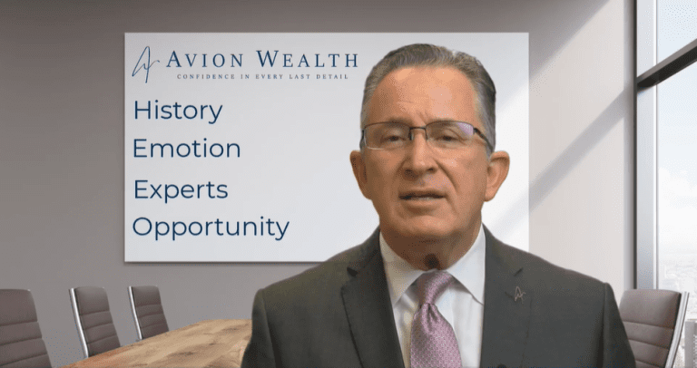 Man in a suit at Avion Wealth office with company values displayed on the wall.