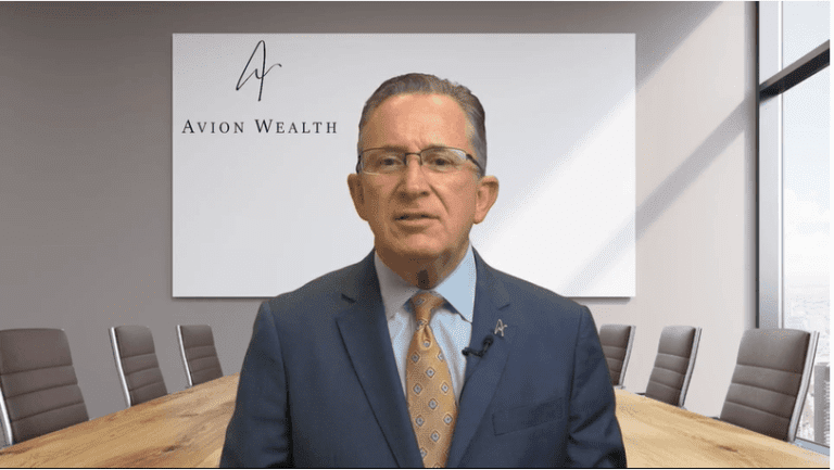 Businessman in office setting with Avion Wealth sign behind.