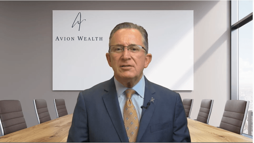 Businessman in office setting with Avion Wealth sign behind.