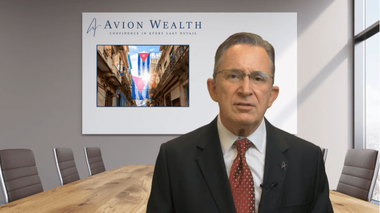 Man in suit in boardroom with Avion Wealth logo on screen.
