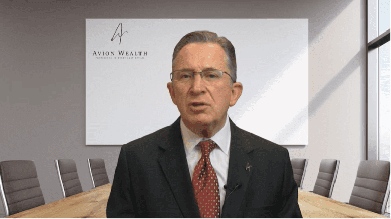 Businessman in a suit speaking in a conference room with Avion Wealth logo.