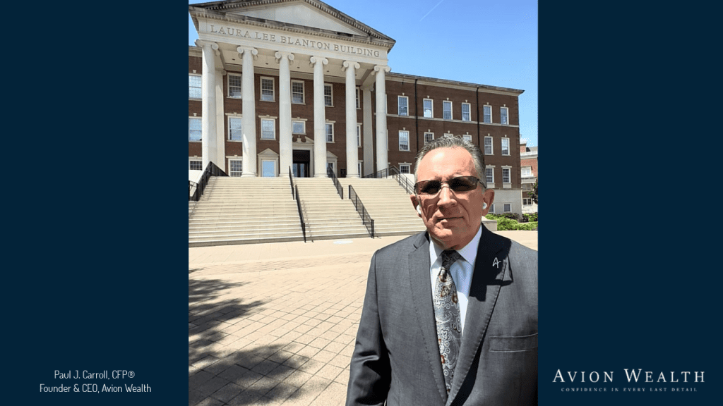Man in a suit standing in front of Laura Lee Blanton Building.