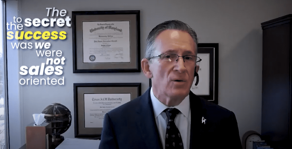 Man in office emphasizes success through non-sales approach.
