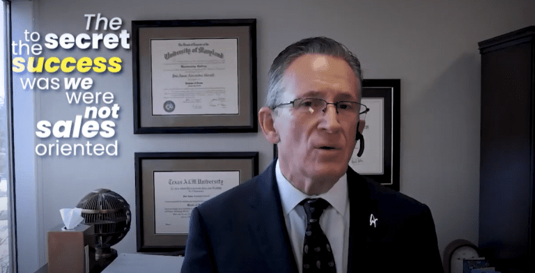 Man in office emphasizes success through non-sales approach.